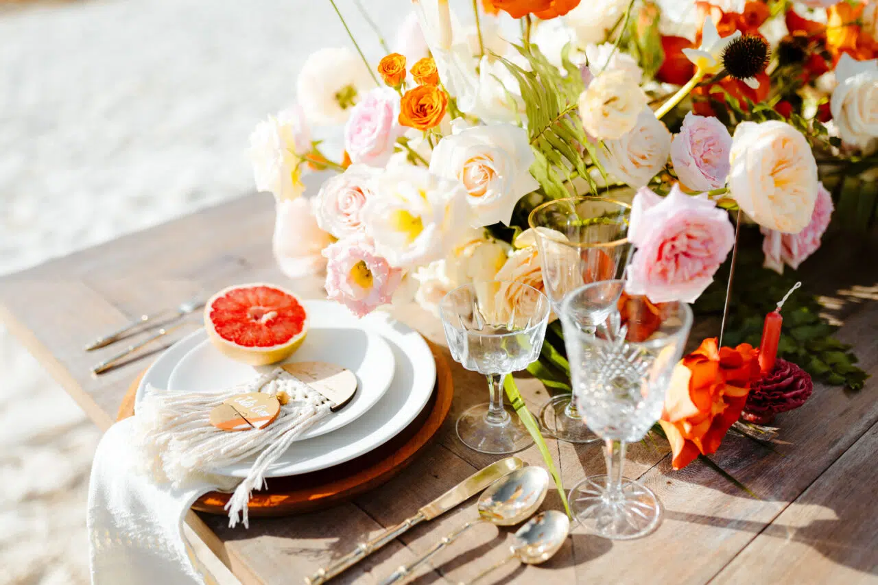 Montaje de mesa boho con flores frescas en la playa